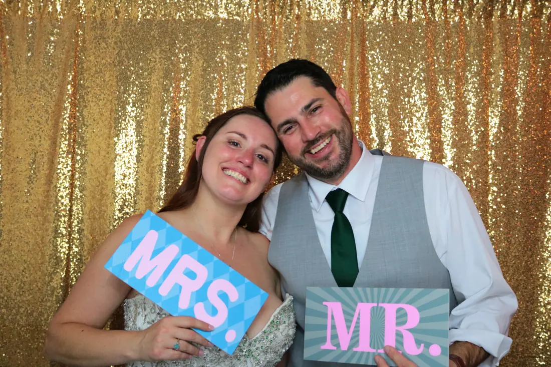 Bride and groom holding Mr. and Mrs. signs